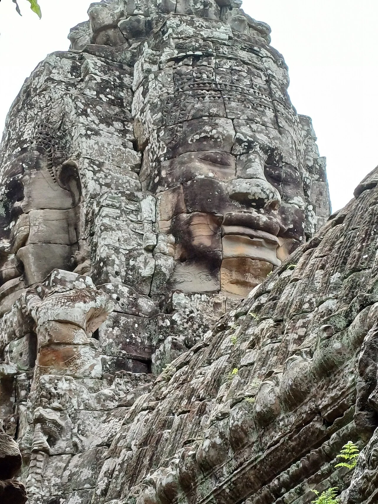 Carved stone faces on Bayon towers, Angkor